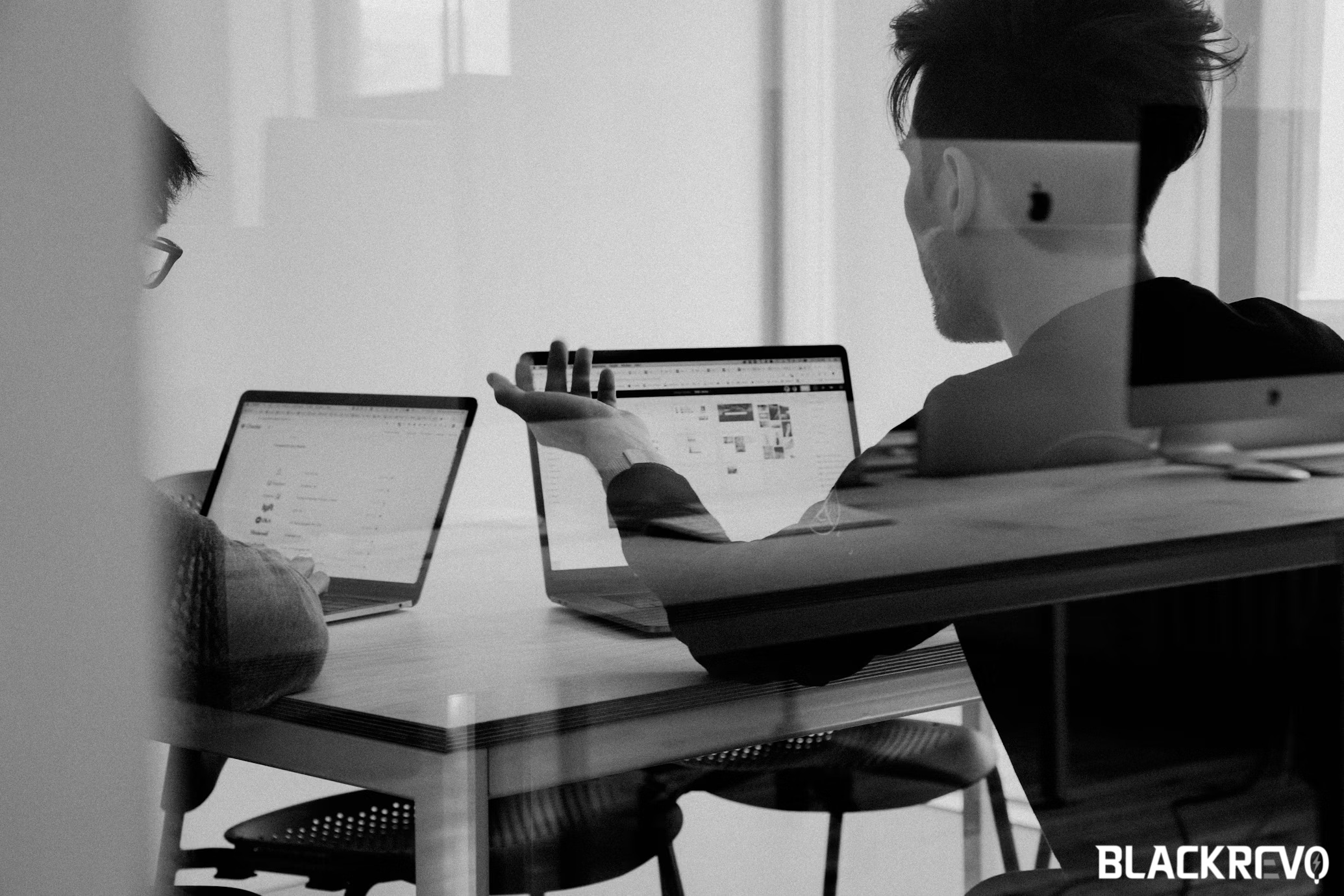 SEO specialists discussing items in meeting room